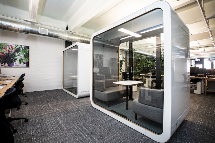 two white phone booths in the office