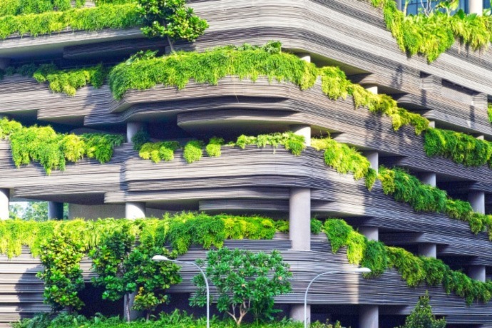 facade of a commercial building filled with green plants