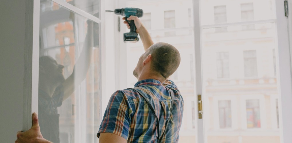 a person fixing a broken window