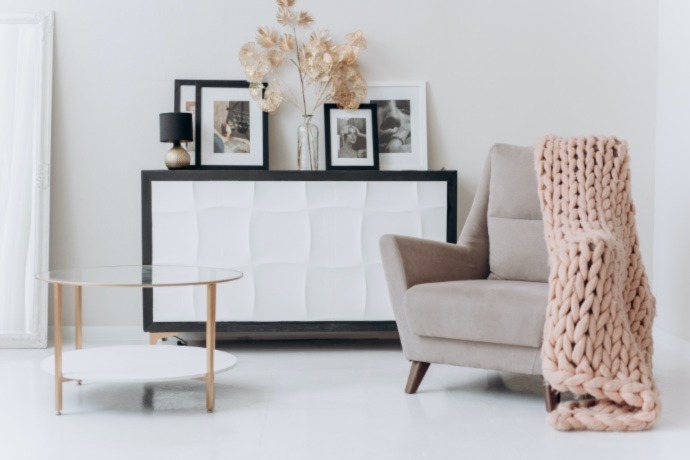 comfortable chair with a big blanket and a coffee table in the office space