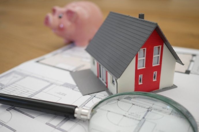 miniature house on the paper with the house renovation plan