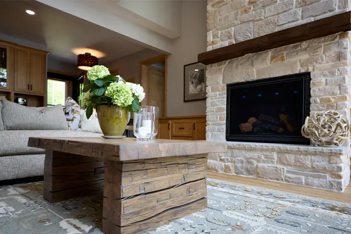 Wooden table facing accent wall made of bricks